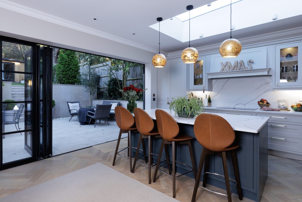 Professional interior property photography of a luxury kitchen with island and garden access in Hampstead, London.